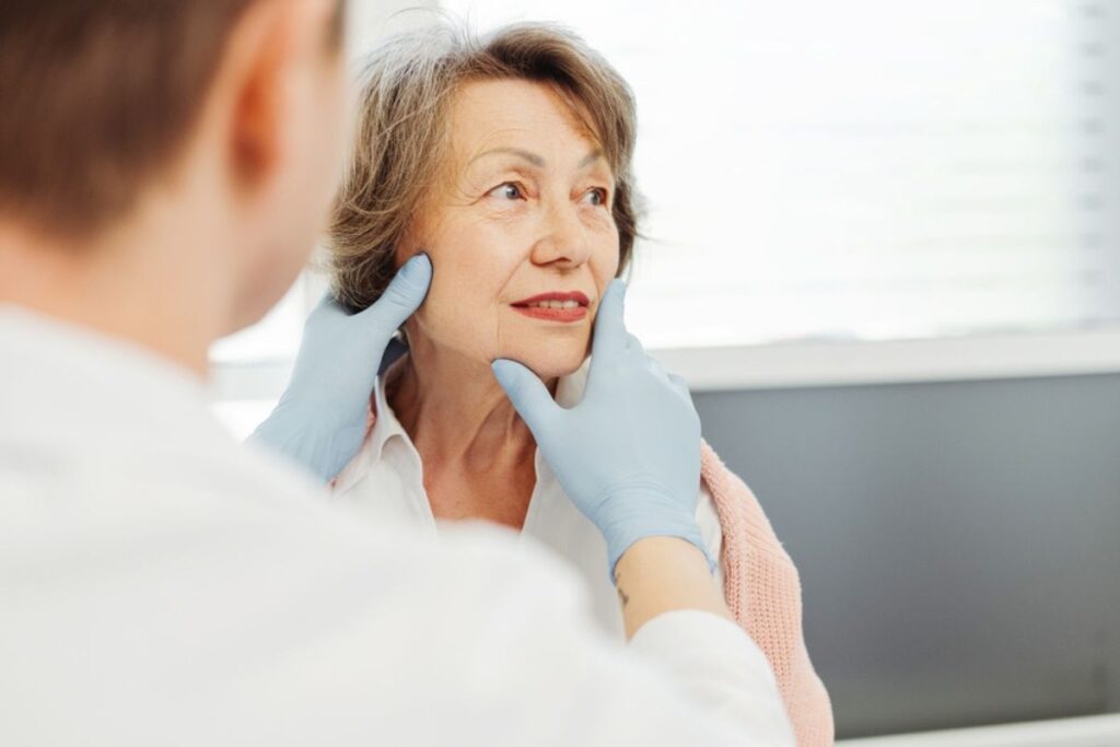 Older woman consulting with doctor about Botox treatment to reduce wrinkles and support graceful aging in her 50s or 60s.