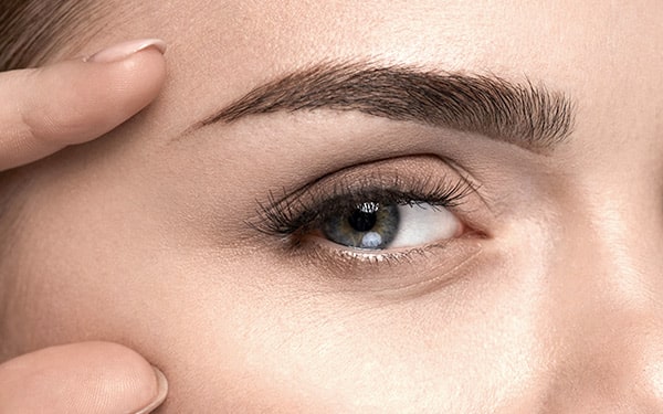Close-up of a woman’s brow and eye area with smooth skin, showing effects of Botox on frown lines and brow lift